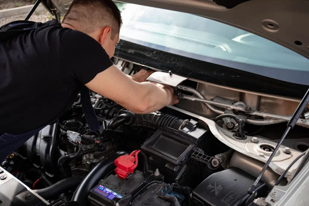 Mechanic working in an open engine bay
